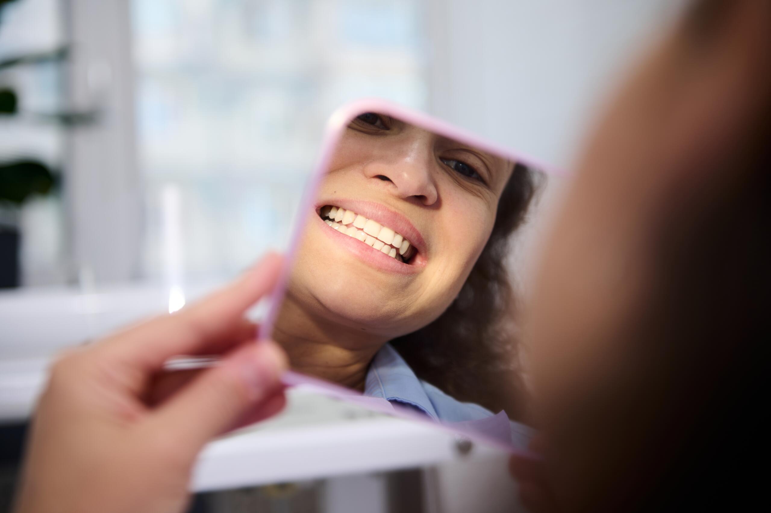 cosmetic dentistry Close-up,Reflection,In,The,Cosmetic,Mirror,Of,A,Pretty,Woman,
